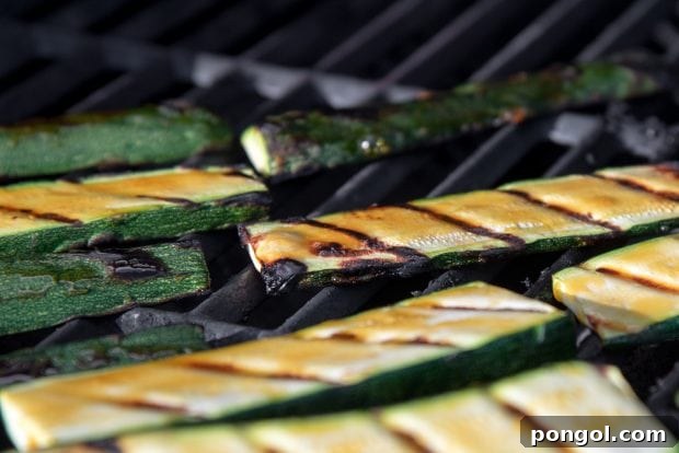Sweet & Smoky Orange Glazed Zucchini (Paleo, Gluten Free) 7 orange glazed zucchini slices cooking on a bbq grill