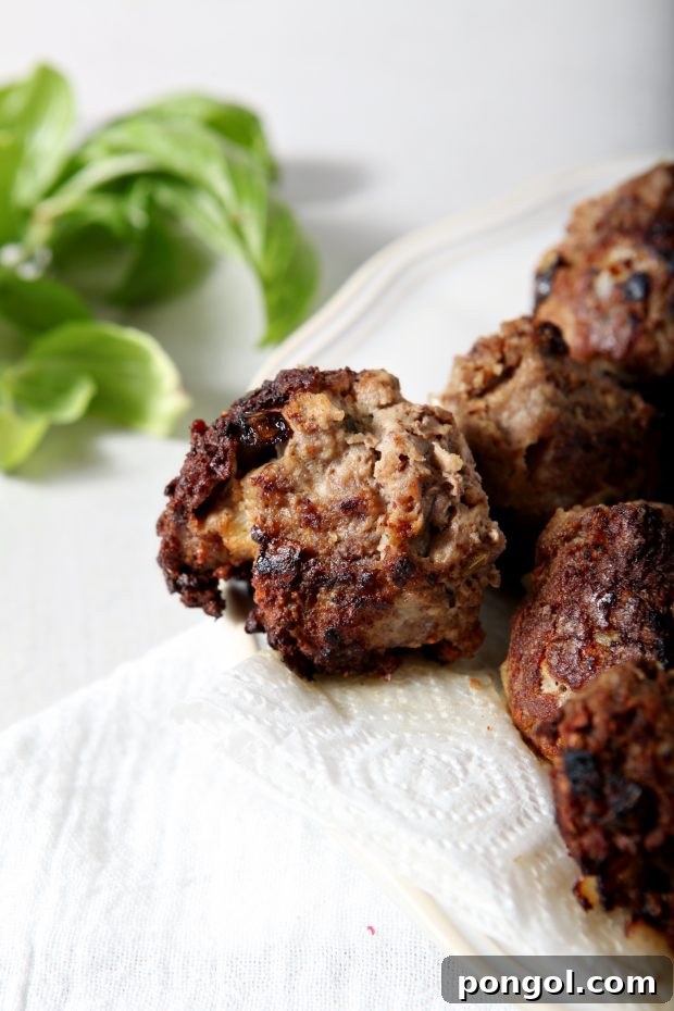 Close-up of Whole30 Meatballs on a plate lined with paper kitchen towels