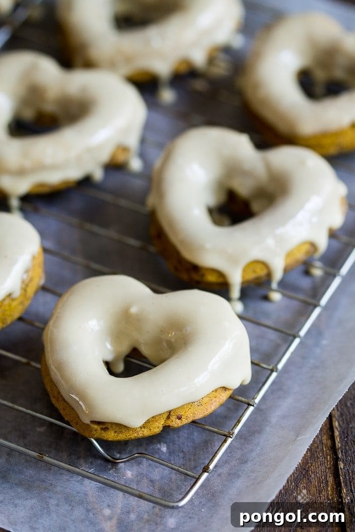 Exquisite Vegan Pumpkin Glaze Donuts, generously coated with a luscious salted caramel glaze, presented invitingly and promising an epic, dairy-free dessert.