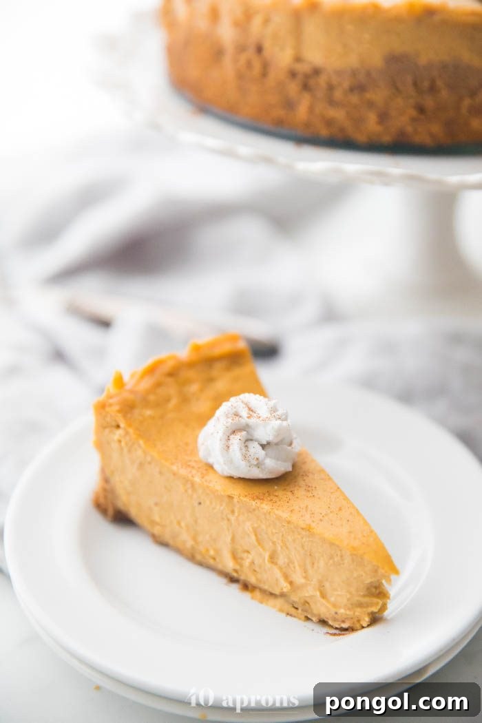 A luxurious slice of Rich Vegan Pumpkin Cheesecake, showcasing its creamy texture and perfectly spiced filling, ready to be enjoyed as a decadent holiday dessert.