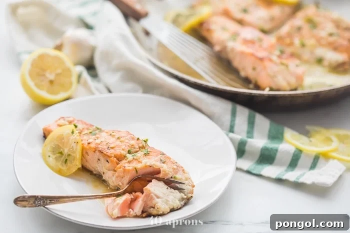 Close-up of lemon garlic salmon with lemon slices, ready to serve.