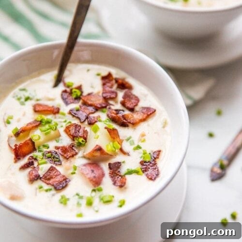 Close up of healthy creamy Whole30 clam chowder in two bowls with bacon and chives