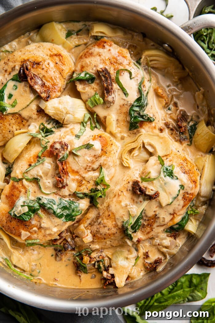 Whole30 Tuscan chicken in a large saucepan, ready to be served, showcasing its vibrant ingredients.