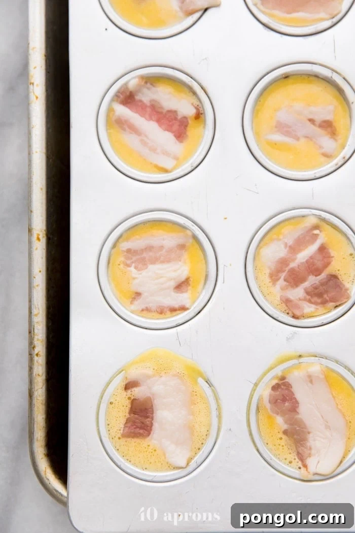 Healthy sous vide egg bites with bacon ready to be baked in a muffin pan