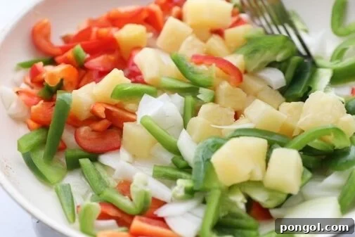 Sauté peppers, onions, and pineapple