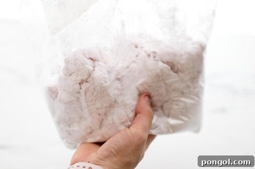 Toss chicken in arrowroot powder