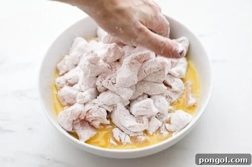 Toss coated chicken in eggs