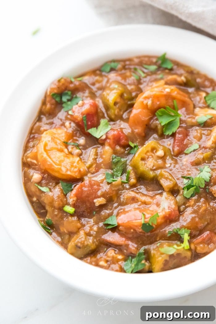 Healthy authentic seafood gumbo in a bowl with shrimp and okra over cauliflower rice in a white bowl