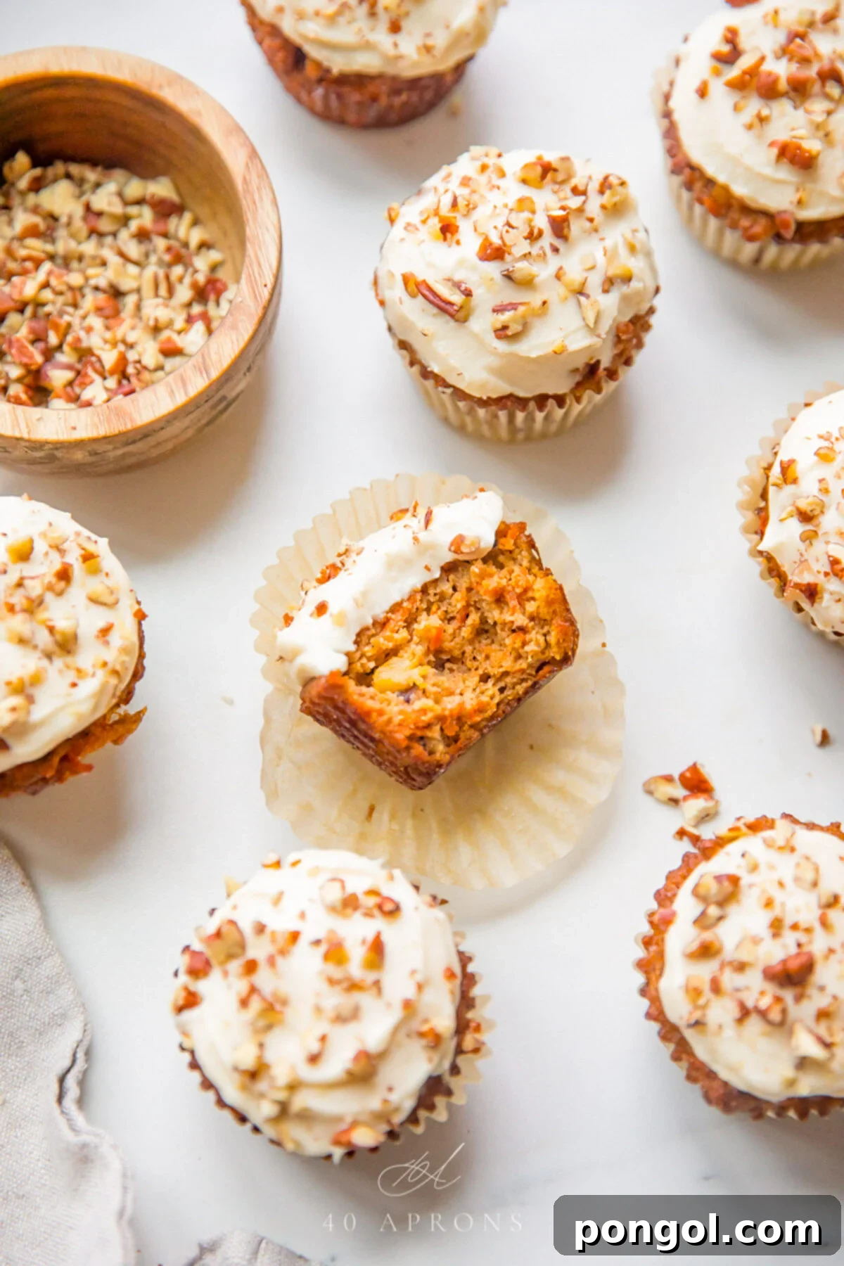 Delicious Paleo Carrot Cake Cupcakes Free From Gluten and Dairy 3 Top-down view of frosted and unfrosted paleo carrot cake cupcakes.