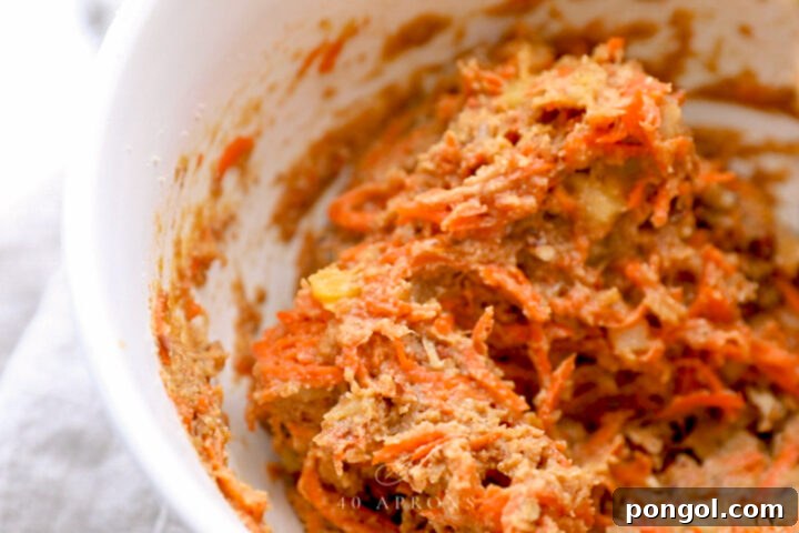 Delicious Paleo Carrot Cake Cupcakes Free From Gluten and Dairy 7 Carrot cake cupcake batter in a large mixing bowl.