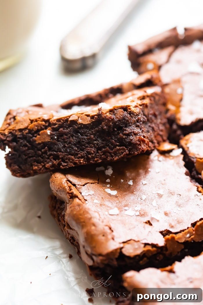 Ultimate Fudgy Crackly Paleo Brownies Gluten Free 4 A batch of the best ever gluten brownies with one balanced on another, showing how fudgy it is with a crispy top