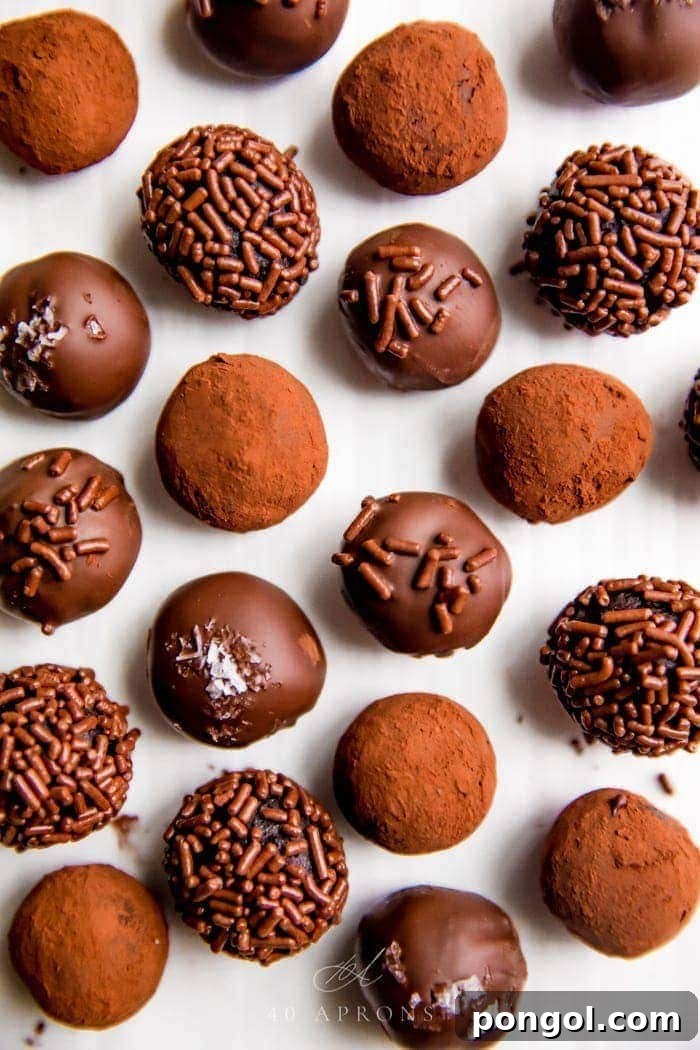 Several healthy vegan chocolate truffles arranged elegantly on a serving platter, showcasing their varied coatings and textures.