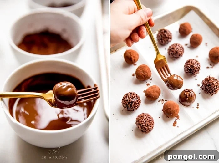 A vegan chocolate truffle being dipped in melted chocolate, ready to be placed on a baking sheet for setting.