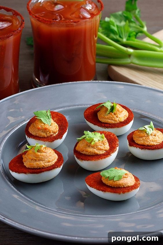 Spicy Bloody Mary Deviled Eggs garnished with celery