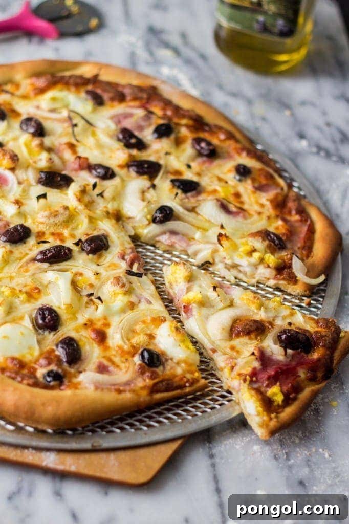 Portuguese pizza topped with slices of hard-boiled eggs