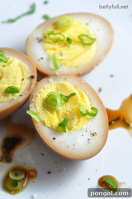 Close-up of halved soy sauce eggs, showing rich brown color