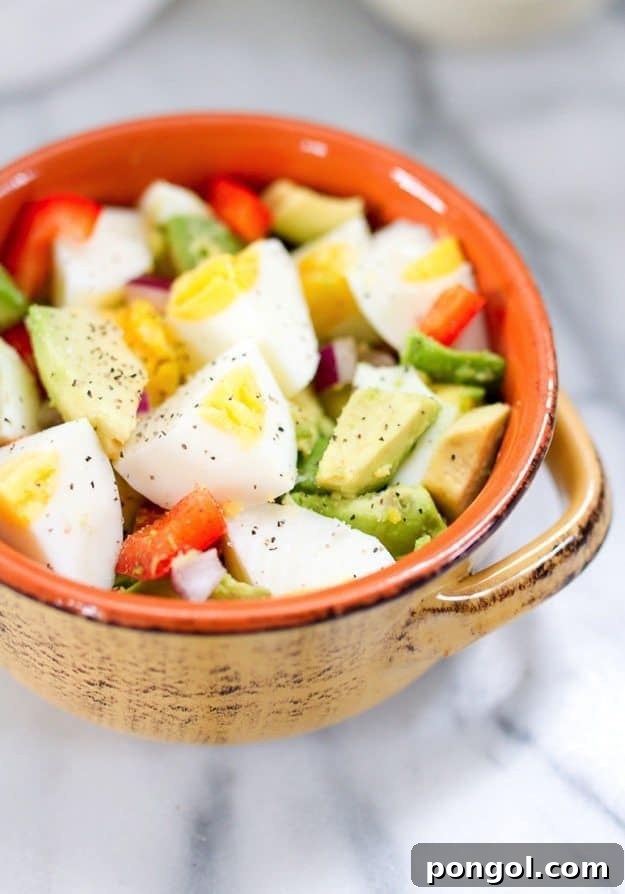 Hard-boiled egg and avocado bowl with a sprinkle of seasoning