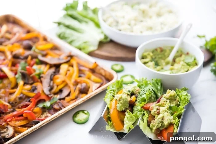 Crisp lettuce wraps filled with vegetarian sheet pan fajitas, served alongside the roasted vegetables, cilantro lime cauliflower rice, and guacamole.