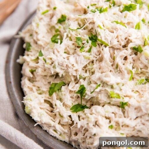 Shredded chicken salad on an antique metal bowl