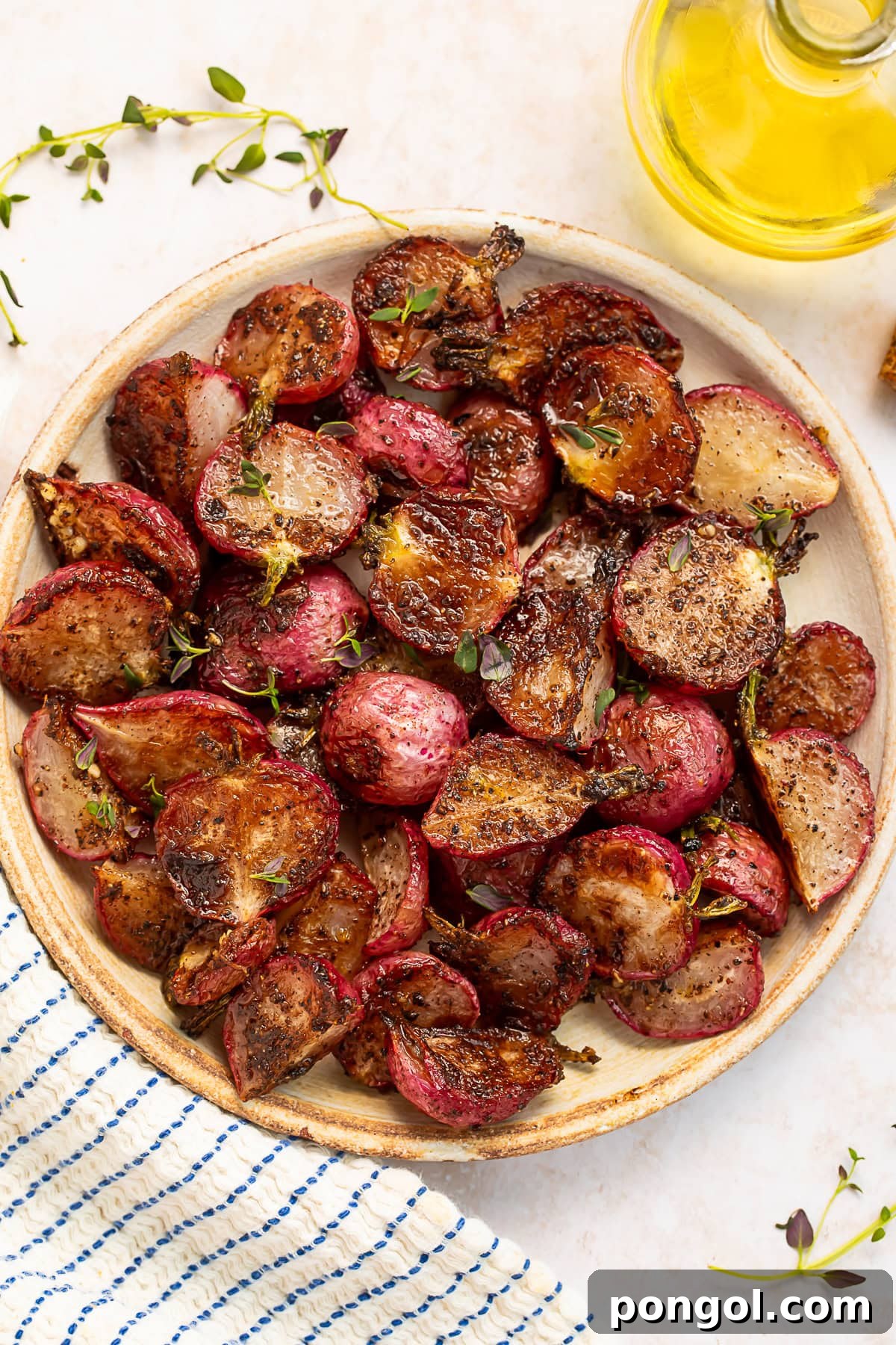 A plate of perfectly roasted radishes drenched in luscious garlic browned butter, garnished with fresh herbs.