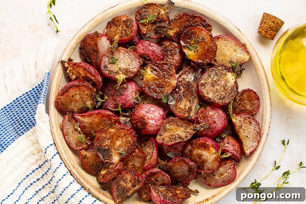 A close-up view of roasted radishes shimmering with garlic browned butter and fresh thyme.