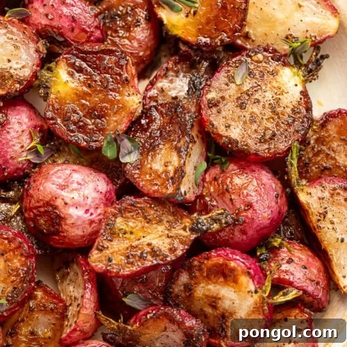 Close-up of a plate of roasted radishes drenched in garlic browned butter.