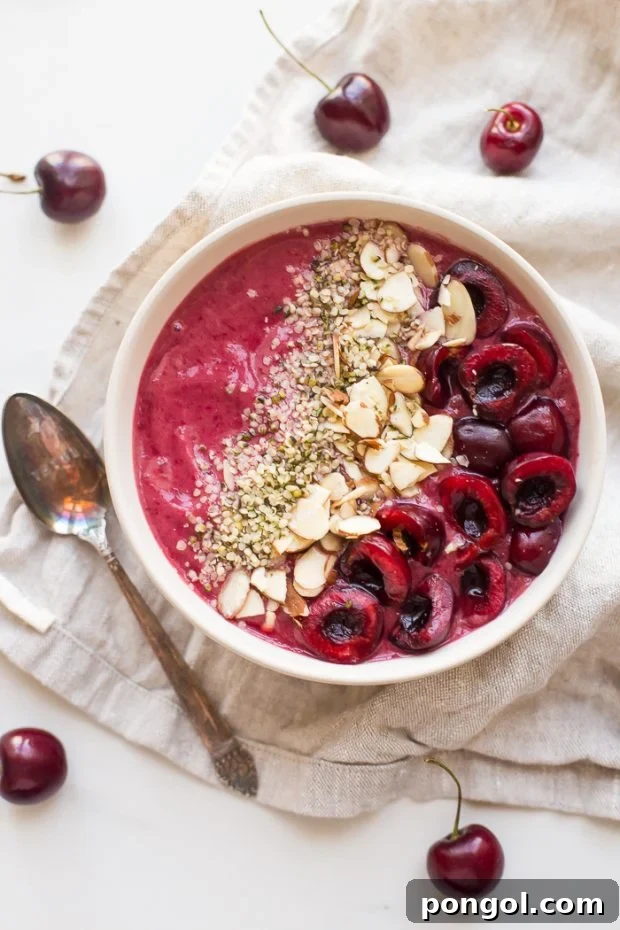 vegan protein sources overhead shot of cherry smoothie bowl topped with vegan protein source hemp hearts