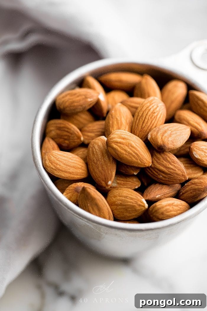 Silver measuring cup of almonds