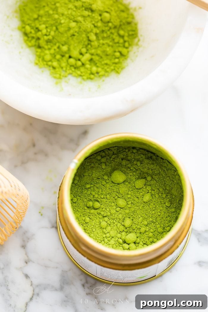 A beautifully designed tin of matcha powder, accompanied by a small bowl of prepared matcha, symbolizing quality and tradition.