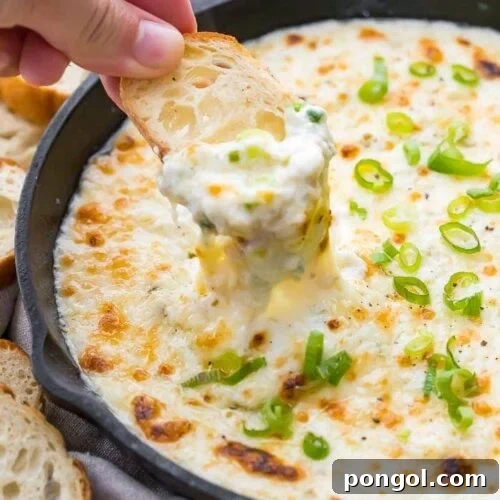Crostini being dipped in the dish