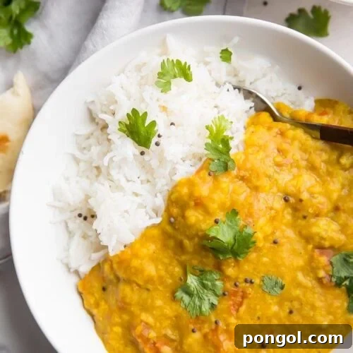 Instant Pot dal over basmati rice in a white bowl