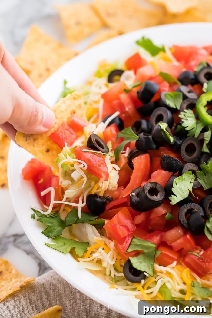 A tortilla scooping up the loaded appetizer