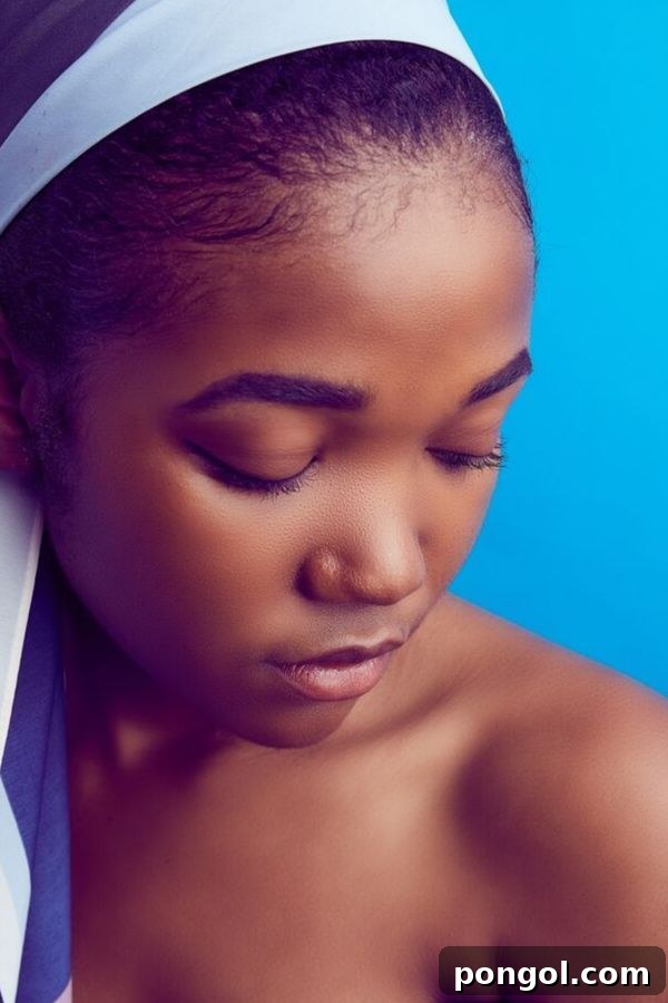 a girl with beautifully clear and smooth skin against a blue background