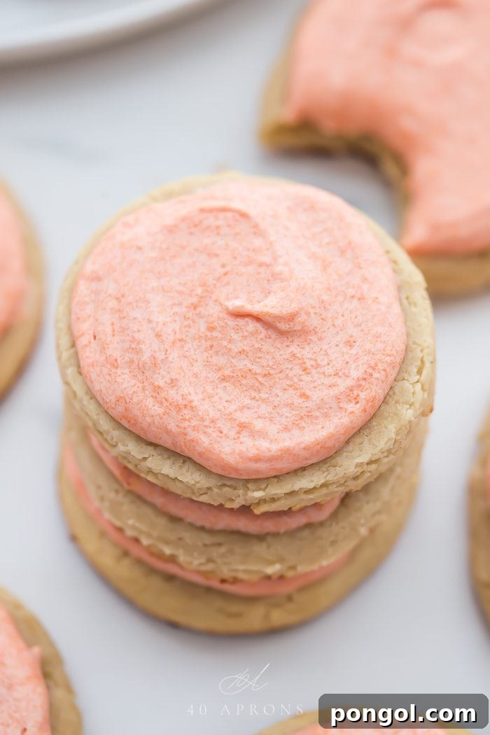 Paleo cookies stacked on top of each other with pink frosting