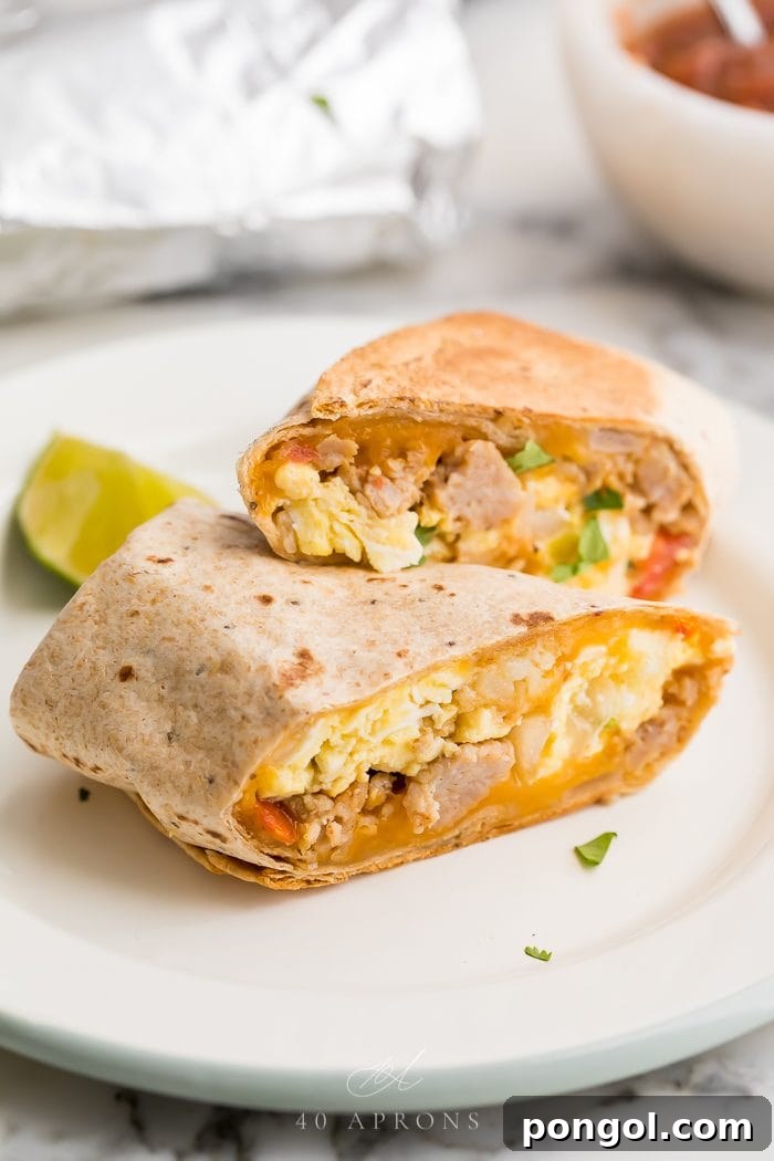 healthy whole wheat breakfast burrito filled with sausage, pico de gallo and scrambled egg on a white plate
