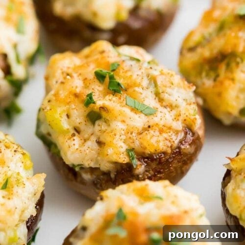 Close up of the appetizer, showing a perfectly golden-brown crab stuffed mushroom
