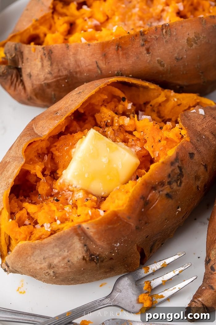 An Instant Pot sweet potato served on a plate, with a pat of melting butter, highlighting its warmth and readiness.