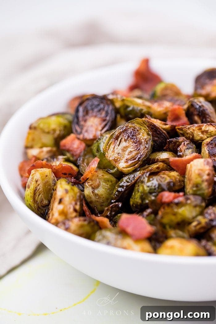 Balsamic Brussels sprouts and crispy bacon in a clean white serving dish, ready to be enjoyed as a side.