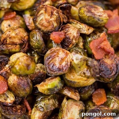 Roasted Brussels sprouts with crispy bacon, glistening with balsamic maple glaze, ready to serve.
