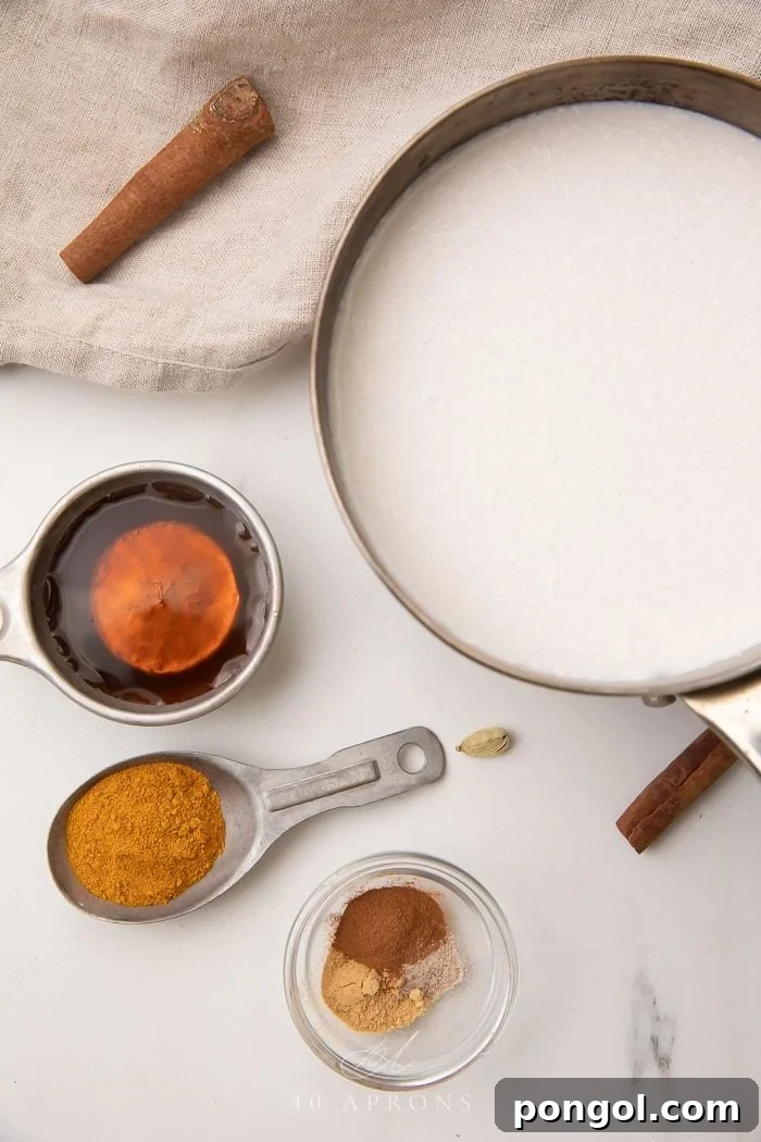 Measuring spoons and cups laid out with individual golden milk ingredients like turmeric, ginger, and cinnamon powder, showcasing the vibrant colors and textures.