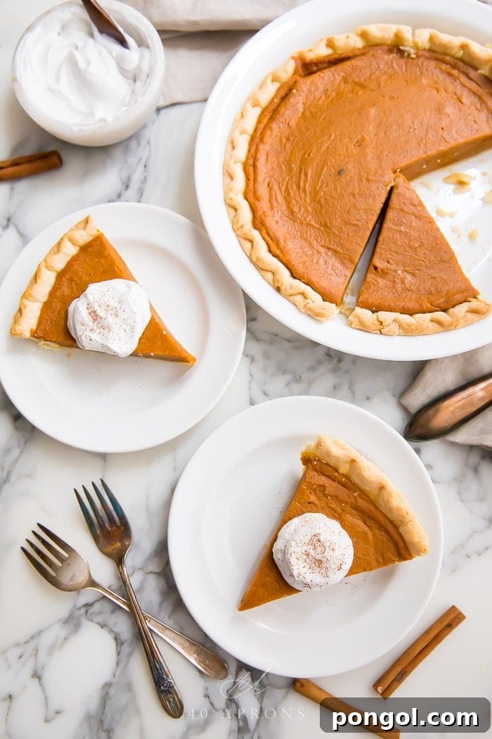 Velvety Vegan Pumpkin Pie 2 Slices of perfectly baked vegan pumpkin pie, garnished with a swirl of whipped coconut cream and a sprinkle of cinnamon, served on elegant white plates, ready for a festive holiday gathering.