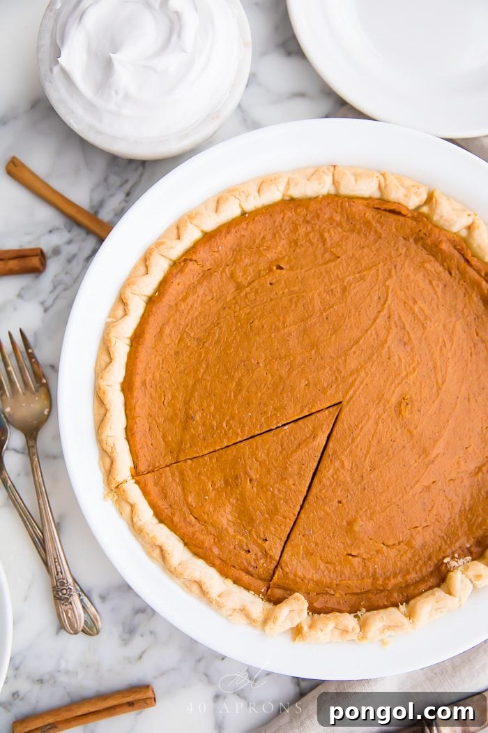 Velvety Vegan Pumpkin Pie 4 A freshly baked vegan pumpkin pie, golden brown and perfectly set in its crust, cooling on a wire rack.