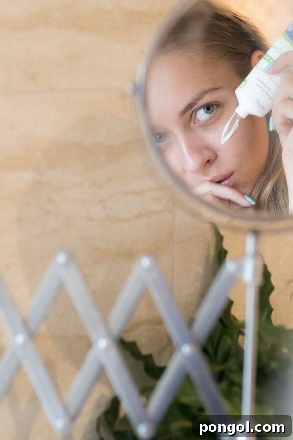 a blond woman applying a glycolic acid skincare product to her face