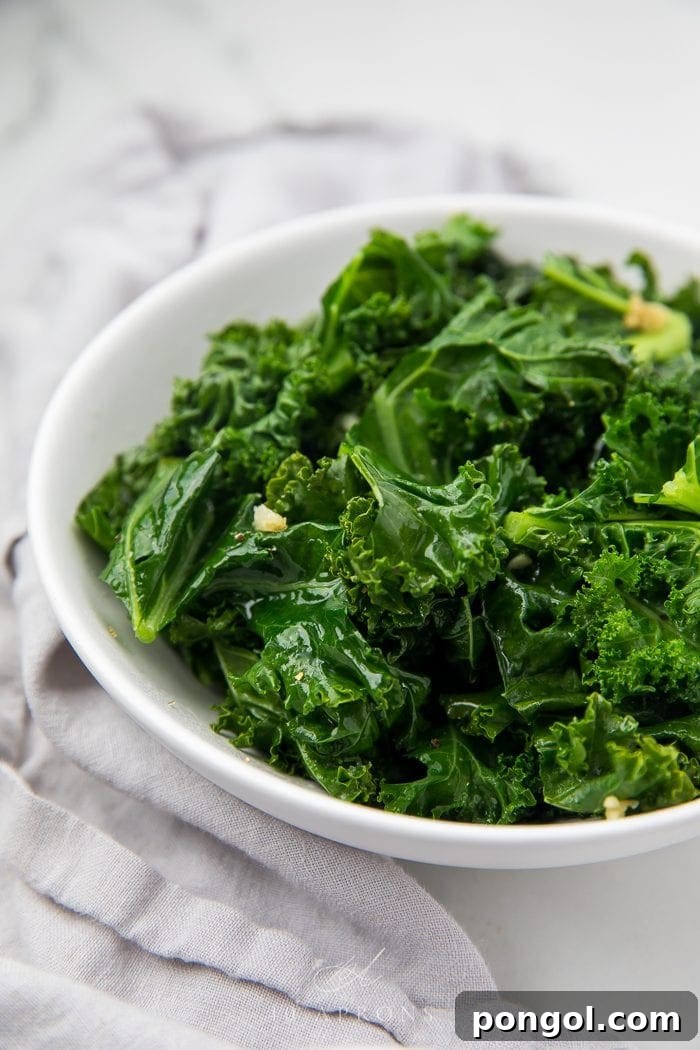 Vibrant green sauteed kale served in an elegant white bowl, ready to be enjoyed as a healthy side dish.
