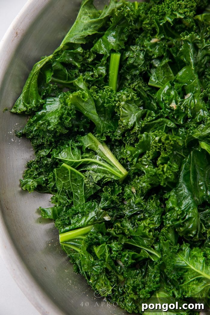 Another close-up of the delicious and healthy sauteed kale dish, highlighting the individual leaves and garlic bits.