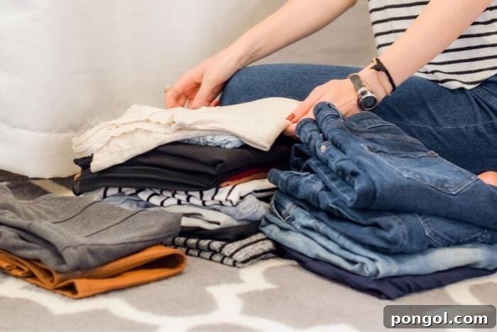a woman sorting through her wardrobe to declutter