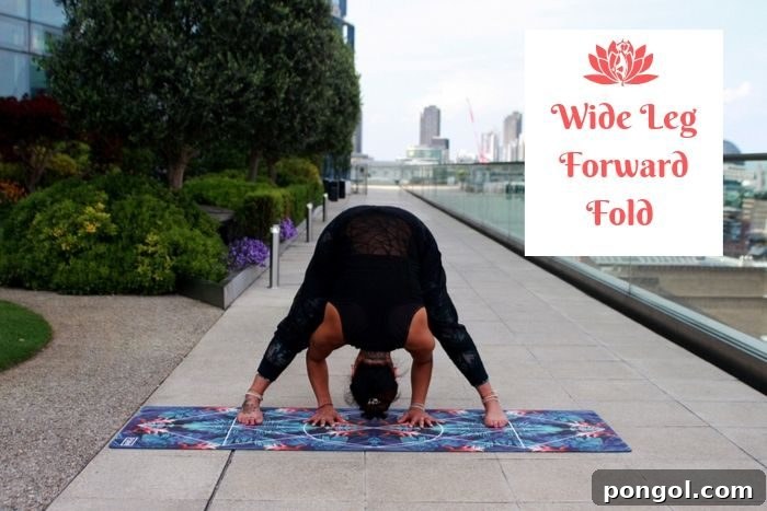 Effortless Detox: 8 Yoga Poses to Cleanse Your System 7 a man holding the yoga detox position of the wide leg forward fold with a city panorama in the background