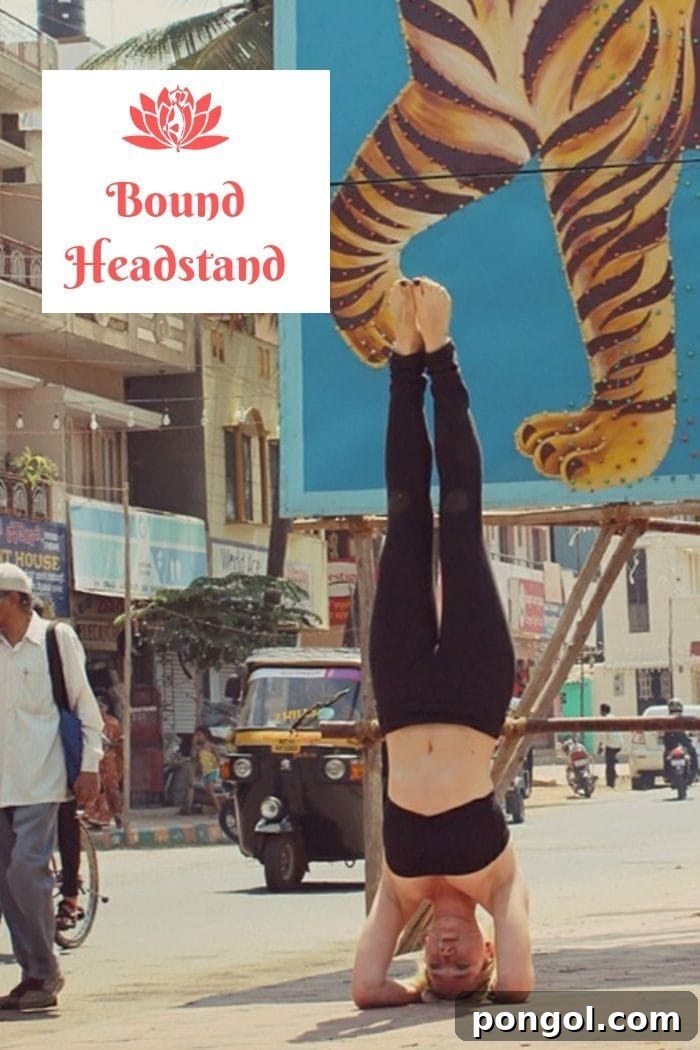 Effortless Detox: 8 Yoga Poses to Cleanse Your System 9 a blonde woman in black workout clothes performing a yoga bound headstand in the streets of Mumbai