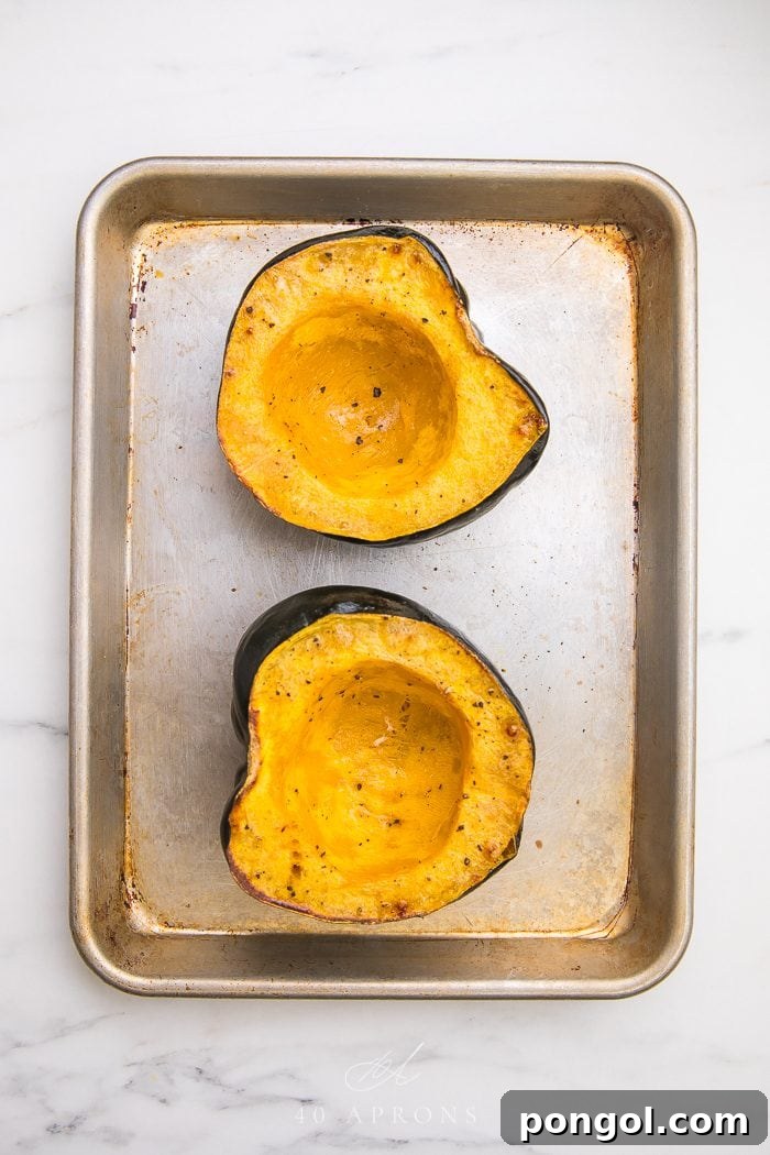 Acorn squash halves perfectly roasted, showcasing their golden-brown edges and tender flesh