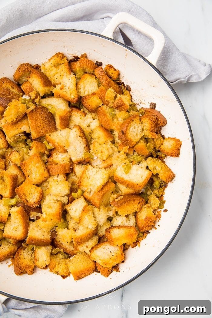Golden-brown gluten-free bread stuffing, perfectly cooked and ready to serve on a white plate